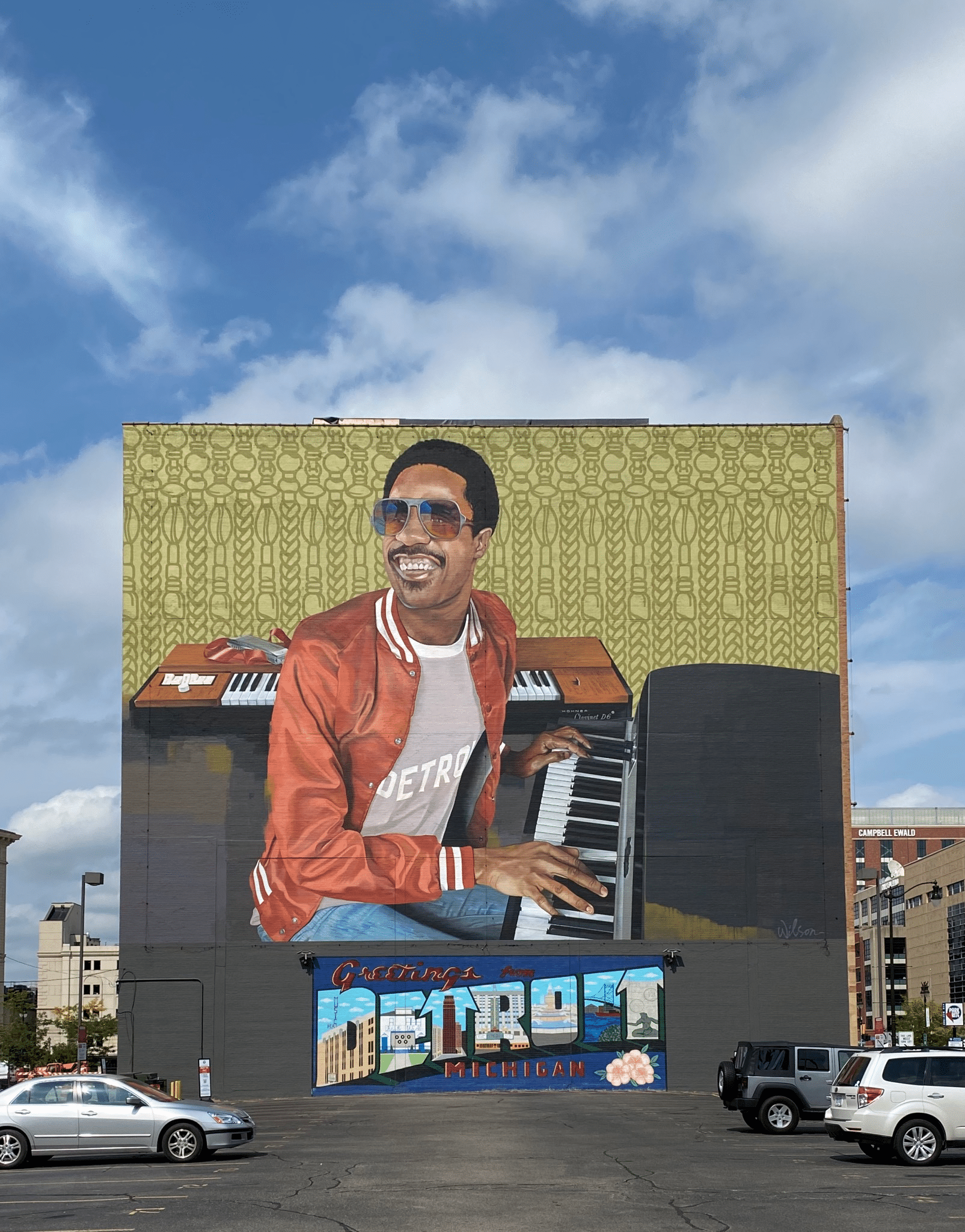 A mural of Stevie Wonder at the piano with Detroit spelled out beneath it