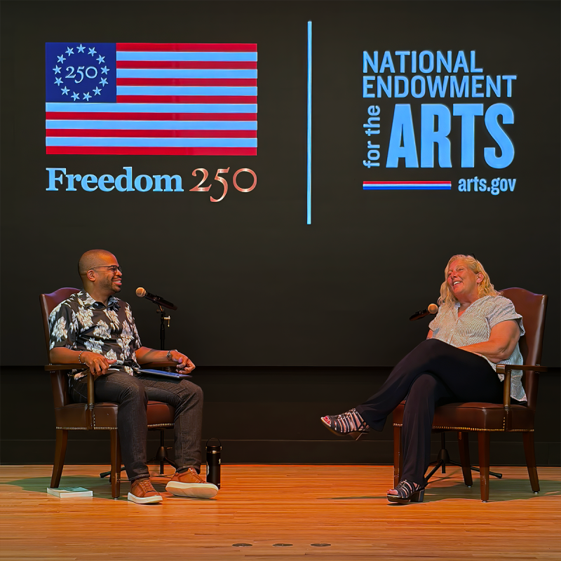 two people on stage having a conversation